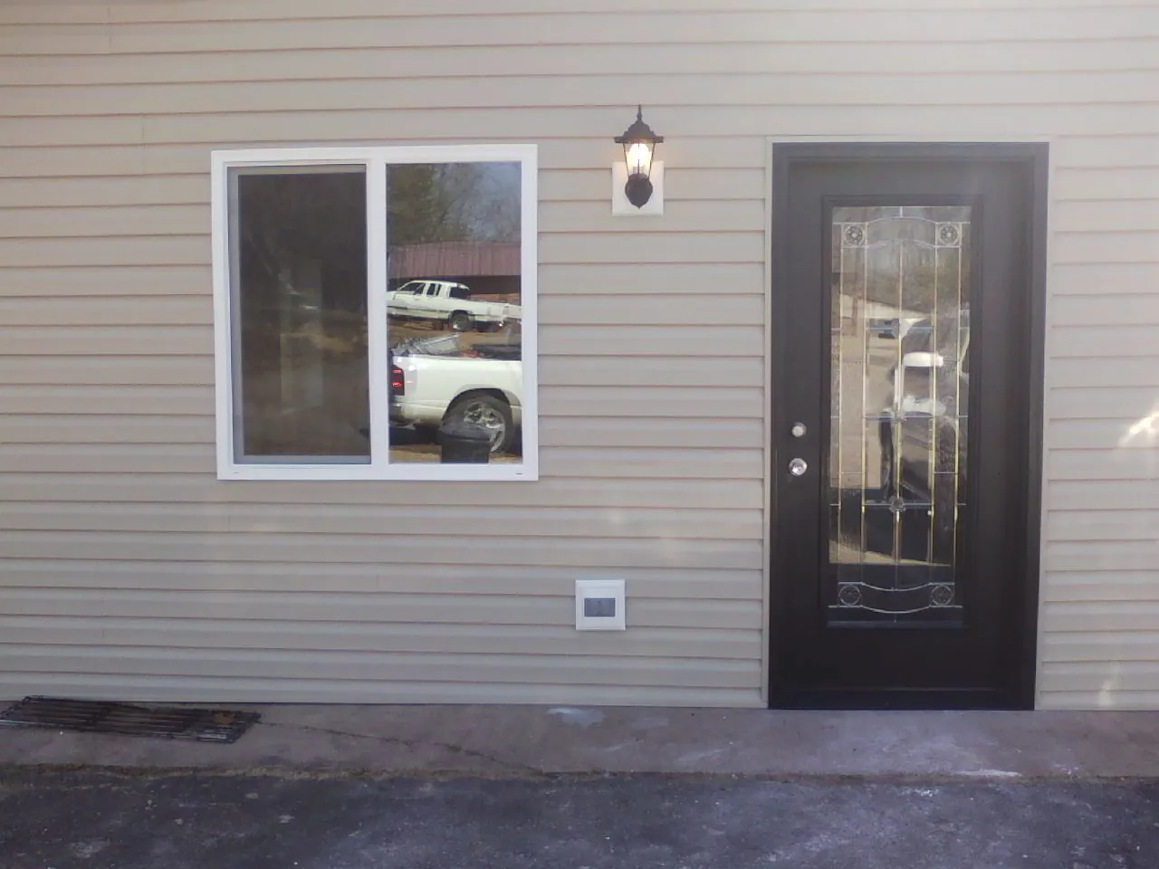 New siding, window and entry door on the side of an addition in Waukee